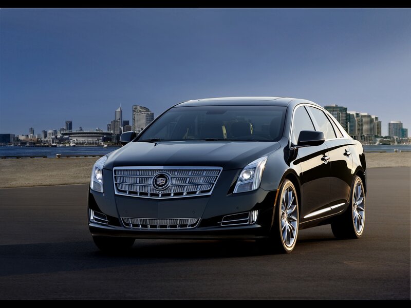 Black Cadillac sedan on waterfront