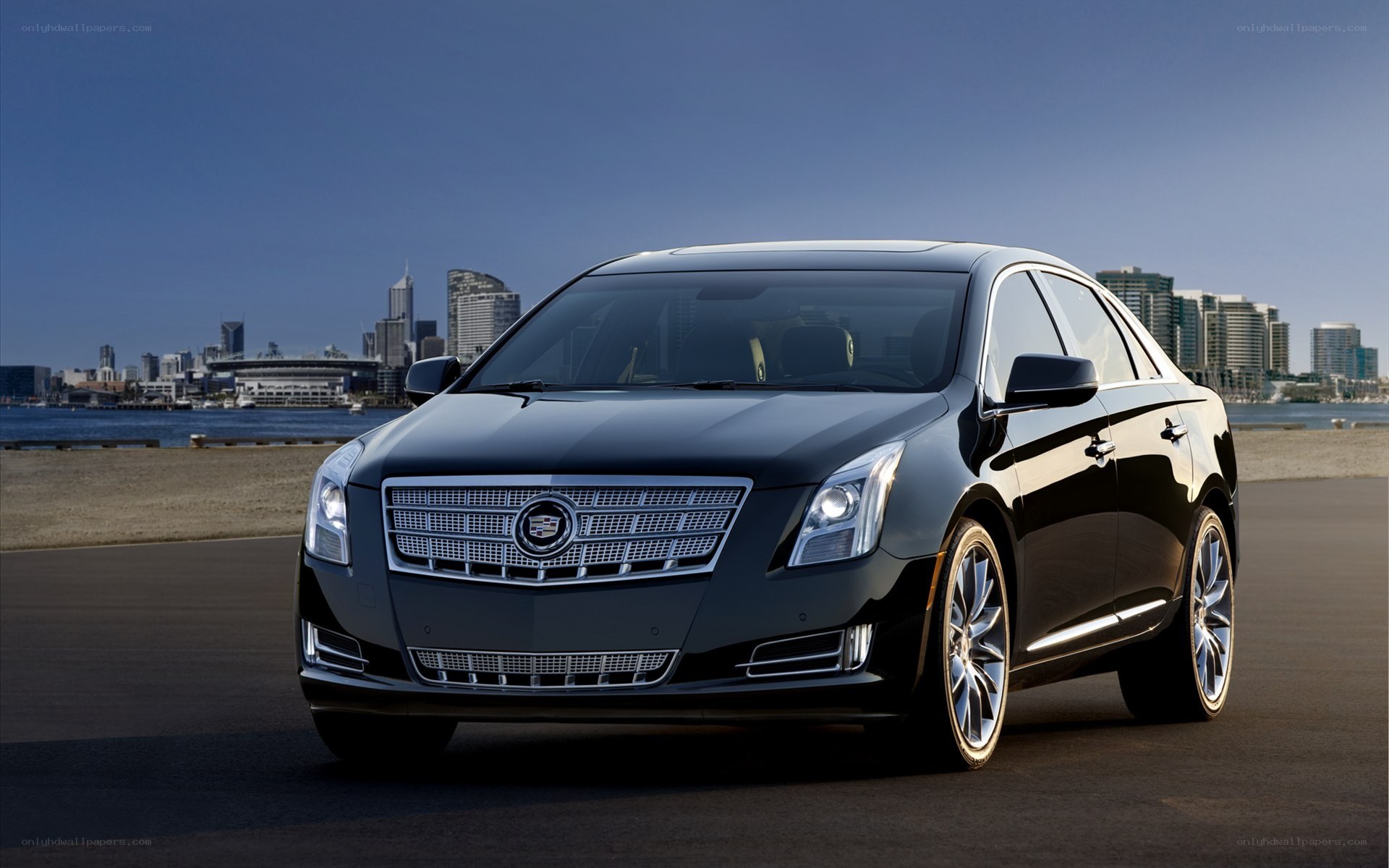 Black Cadillac sedan on waterfront