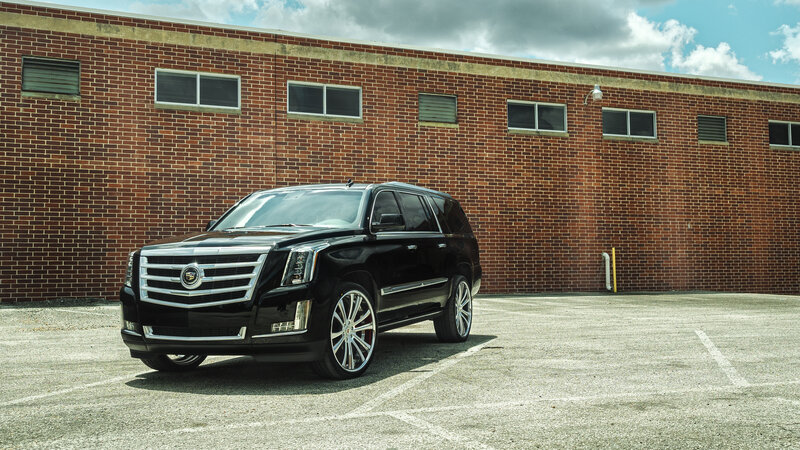 Black Cadillac SUV in parking lot