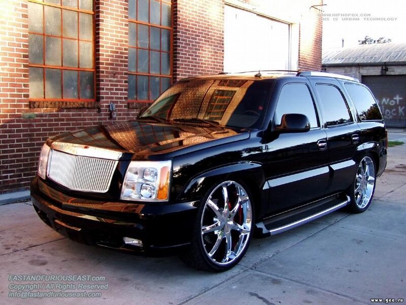 black cadillac suv on street