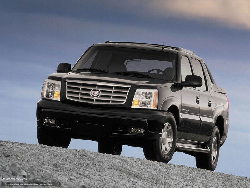 black cadillac truck on gravel