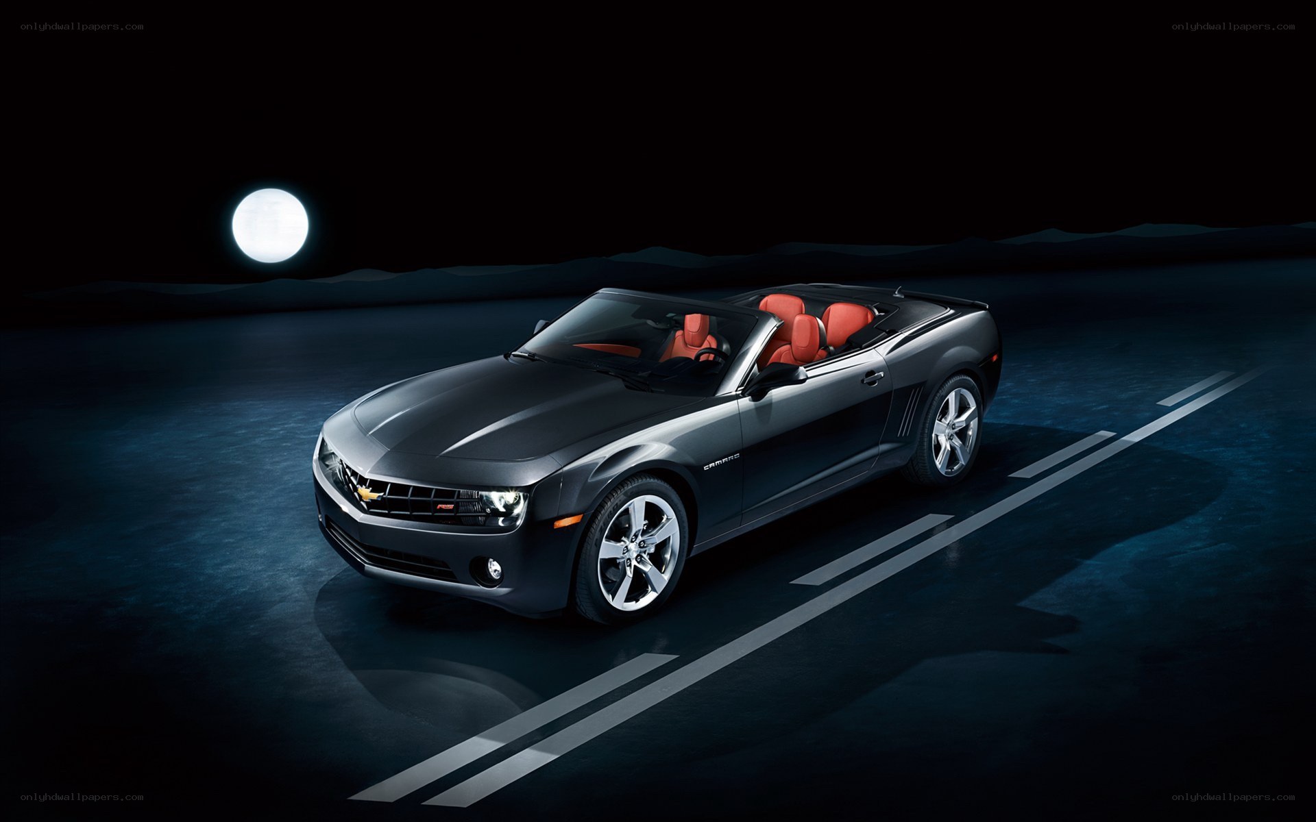 Black Camaro convertible at night