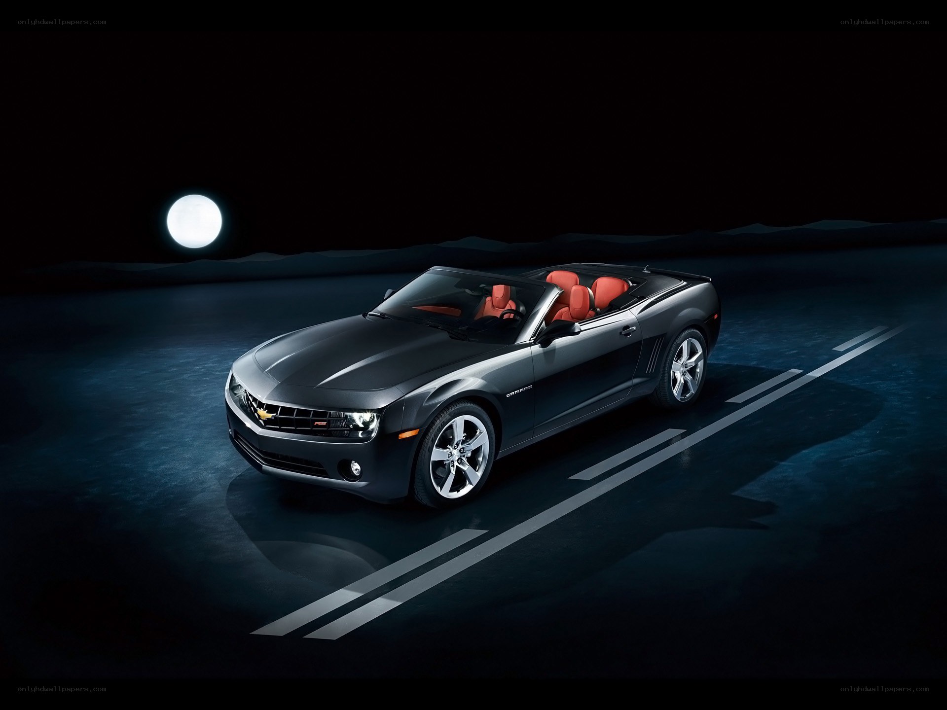 Black Camaro convertible at night