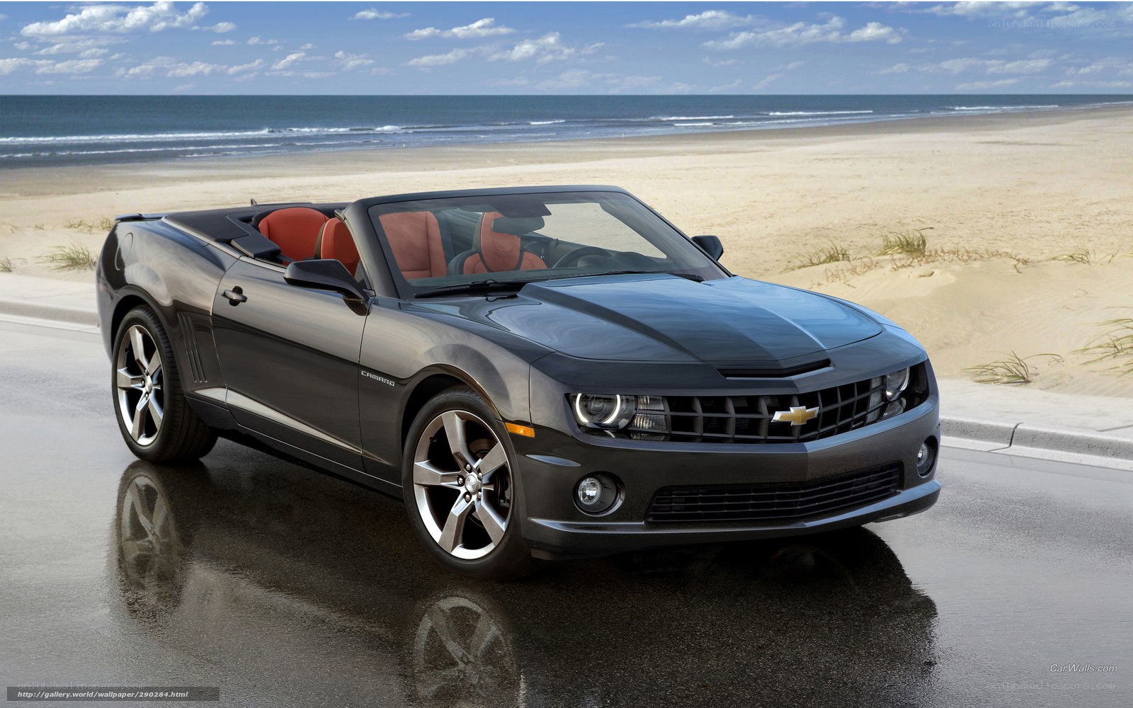 Black Camaro convertible on beach
