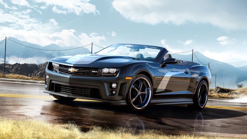 Black Camaro convertible on mountain road