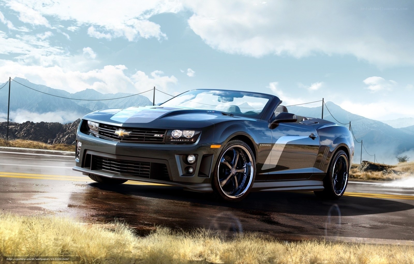 Black Camaro convertible on mountain road