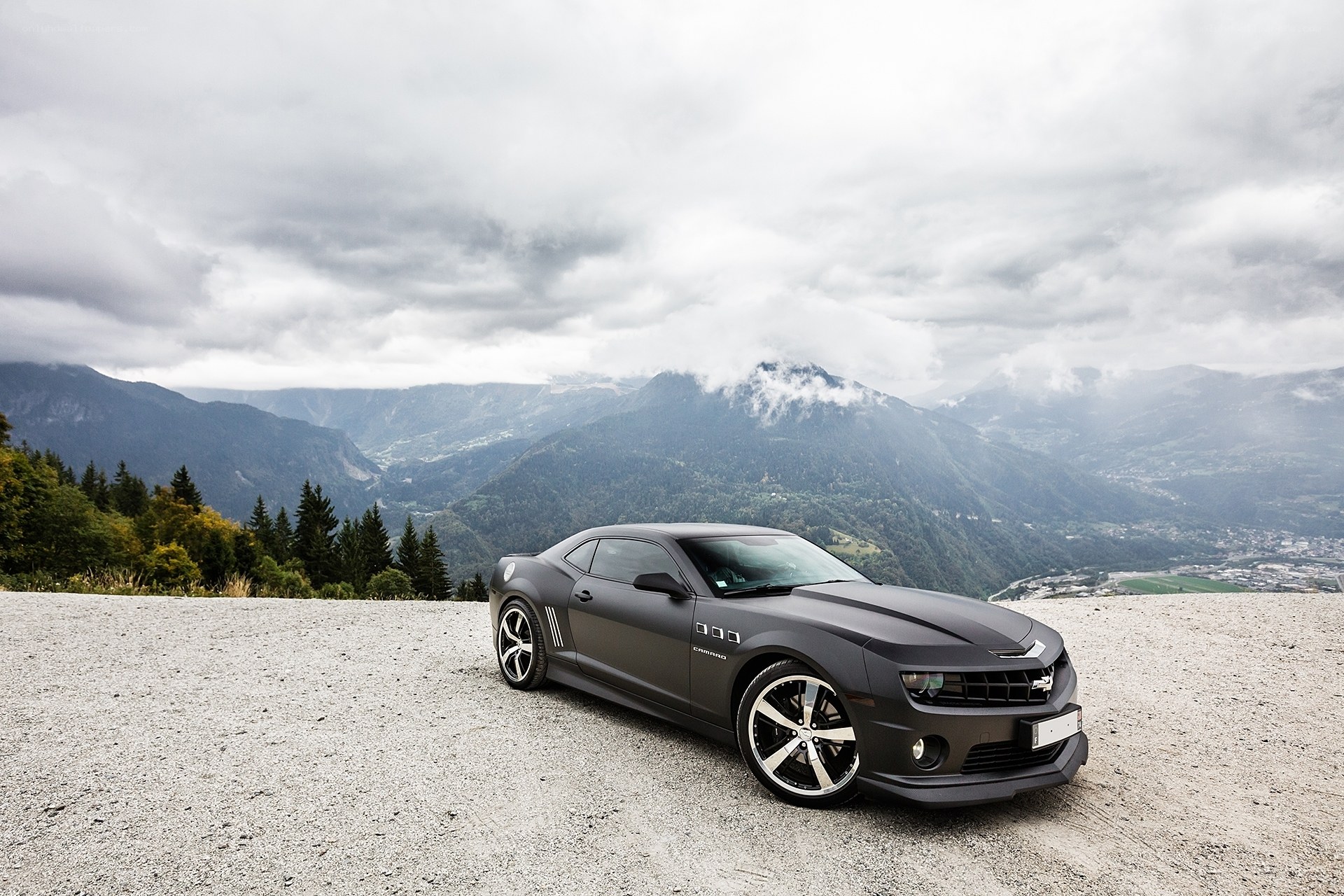 Black Camaro on a mountain road