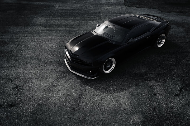 black camaro on asphalt