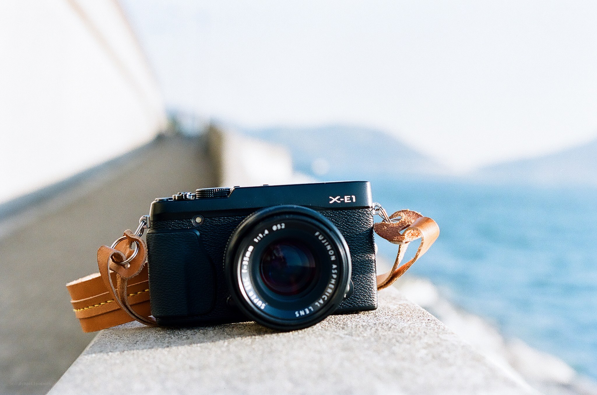 Black camera on seaside wall