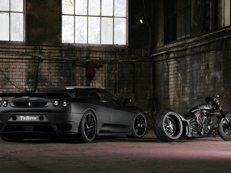 Black car and motorcycle in warehouse