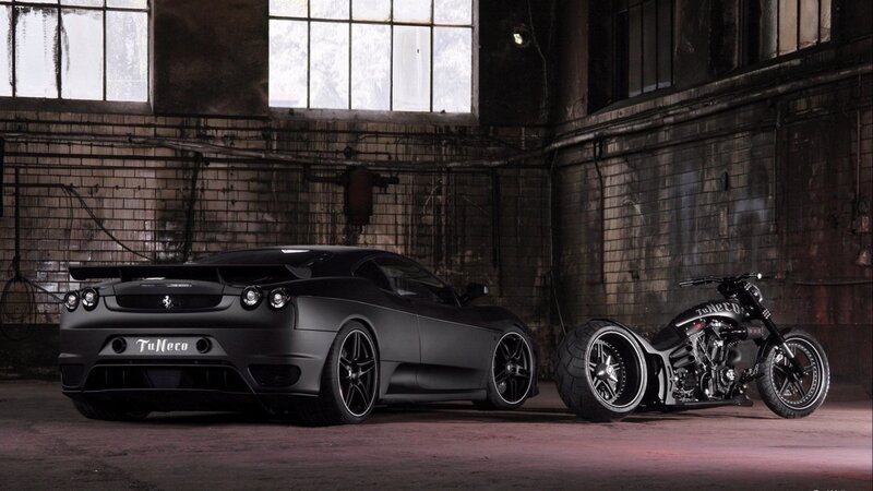 Black car and motorcycle in warehouse