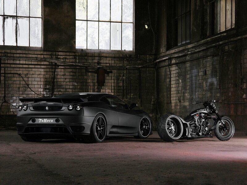 Black car and motorcycle in warehouse