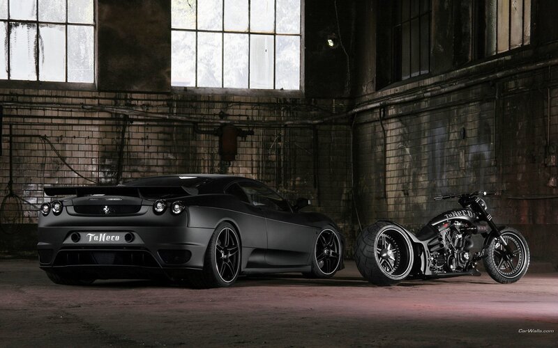 Black car and motorcycle in warehouse