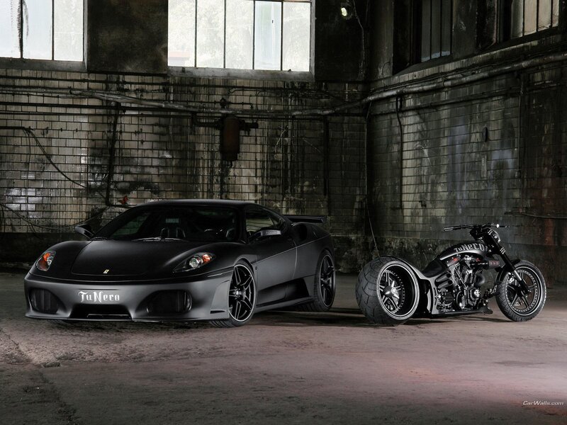 Black car and motorcycle in warehouse