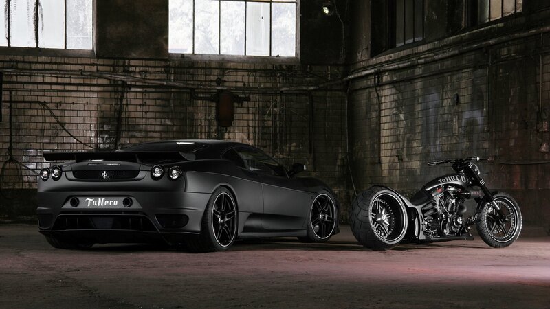 Black car and motorcycle in warehouse