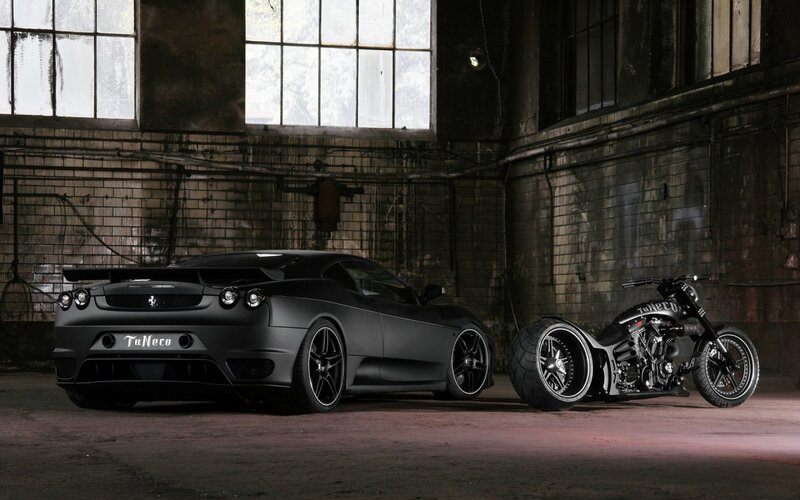 Black car and motorcycle in warehouse
