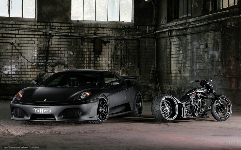 Black car and motorcycle in warehouse