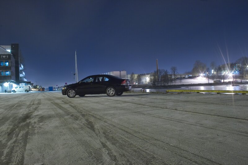 Black car at night by the water