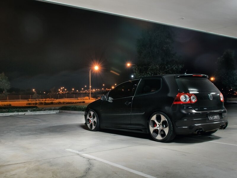 Black car at night in parking lot