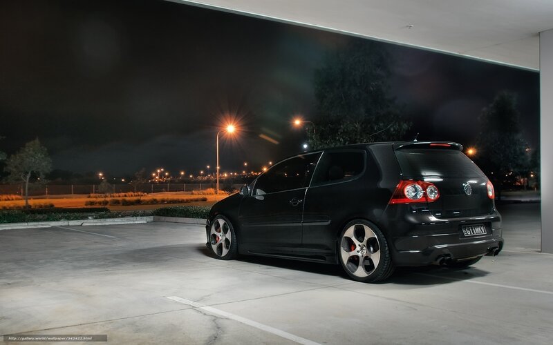 Black car at night in parking lot