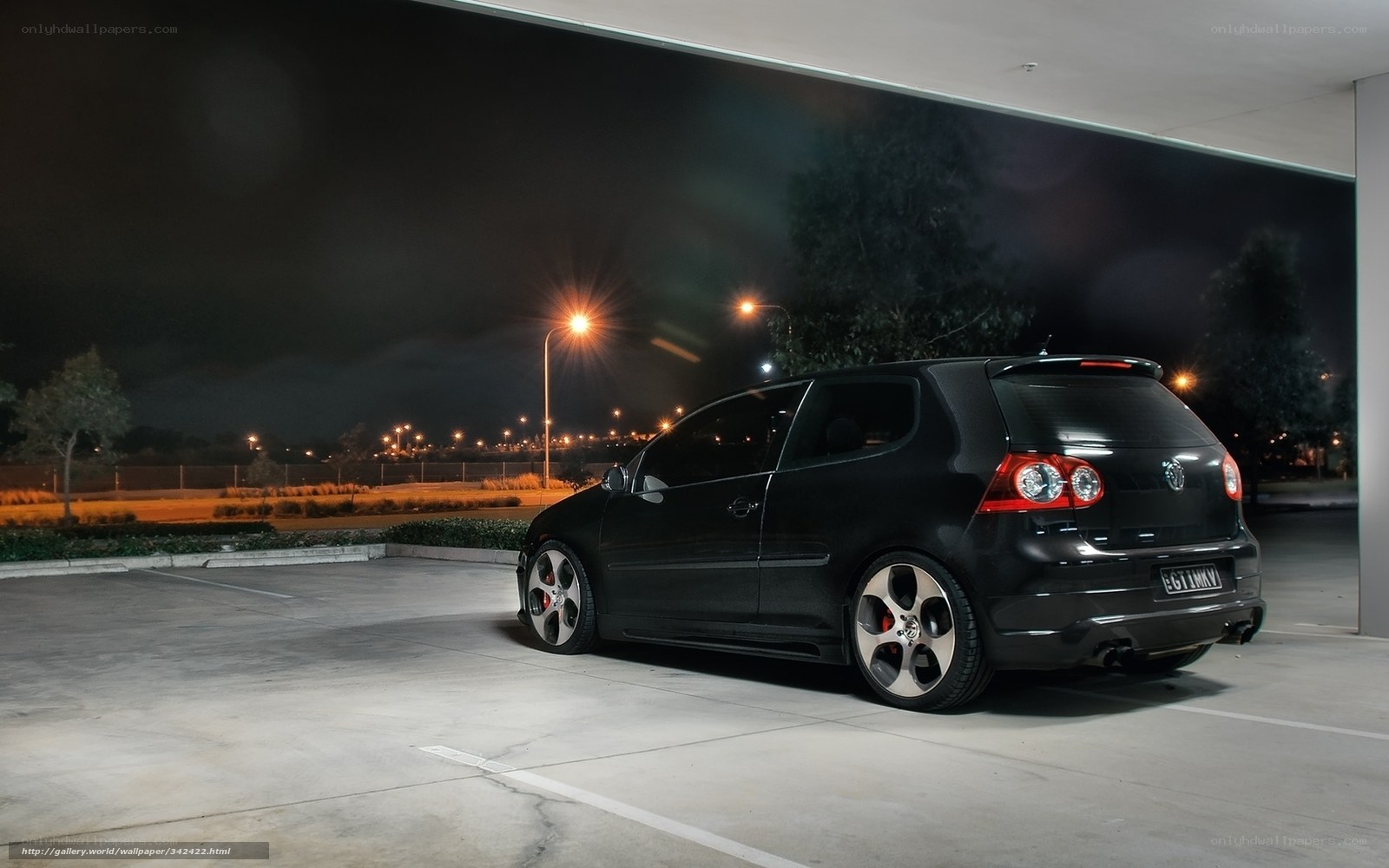 Black car at night in parking lot