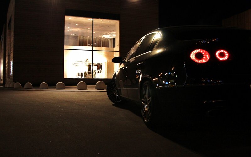 black car at night near building