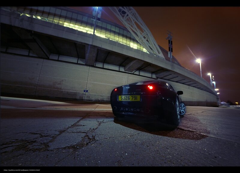Black car at night near stadium