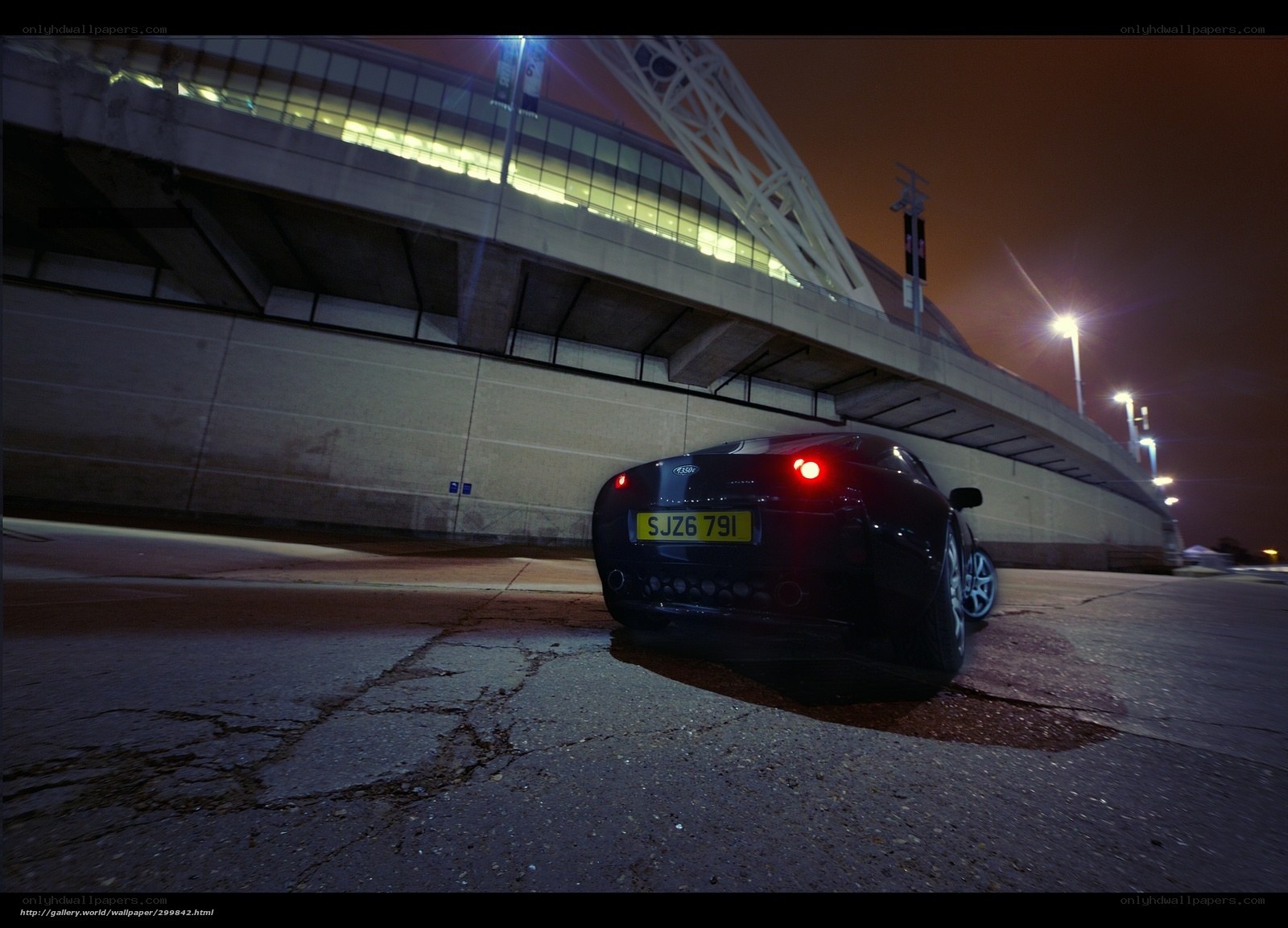 Black car at night near stadium