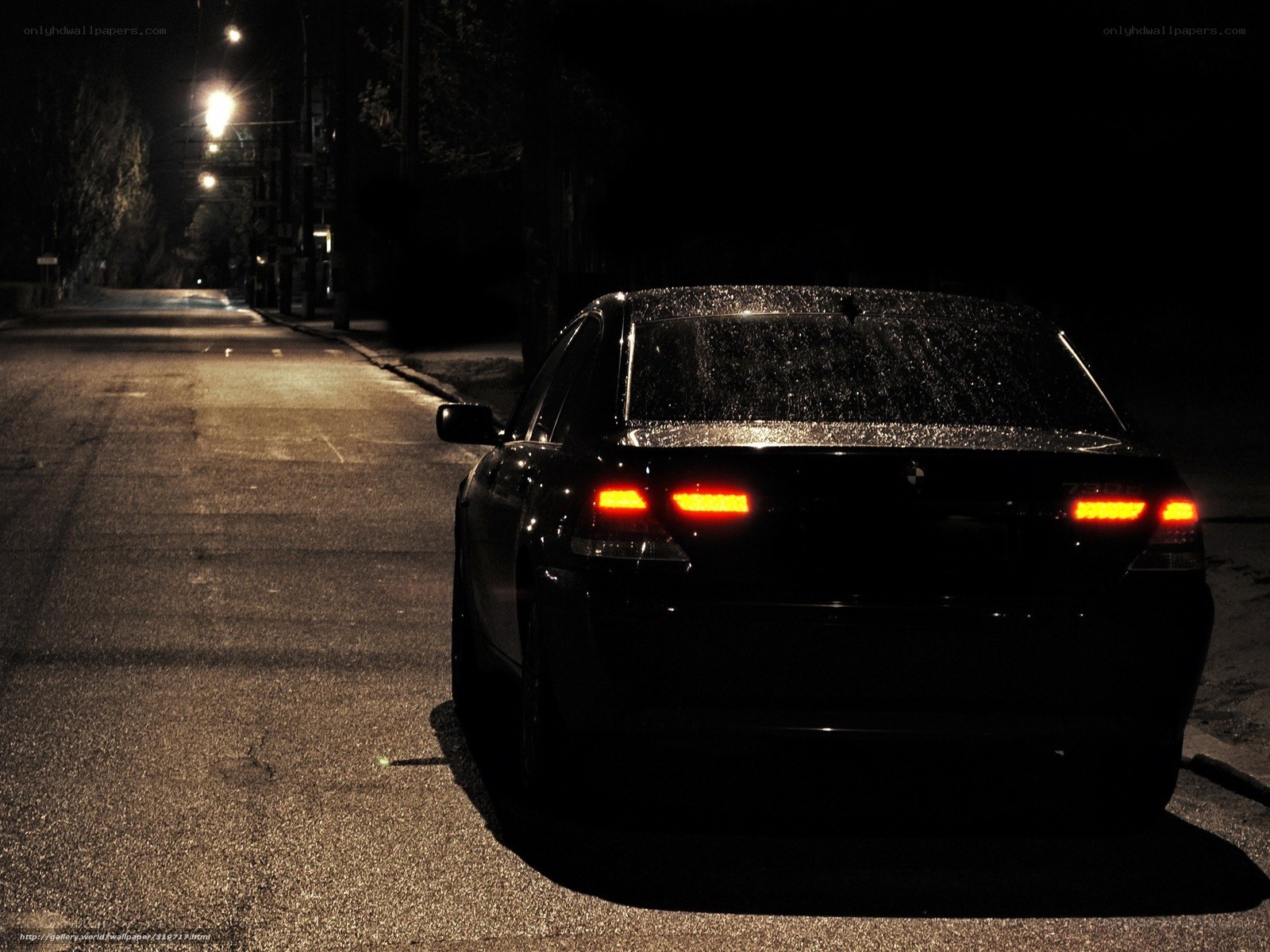 Black car at night on wet street