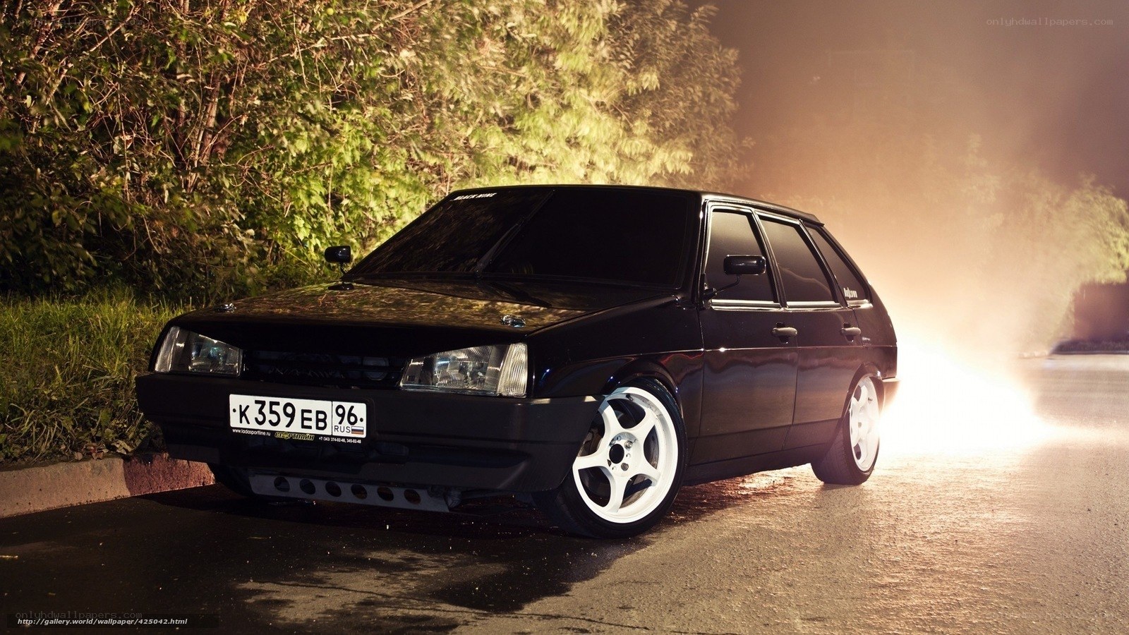 Black car at night with smoke