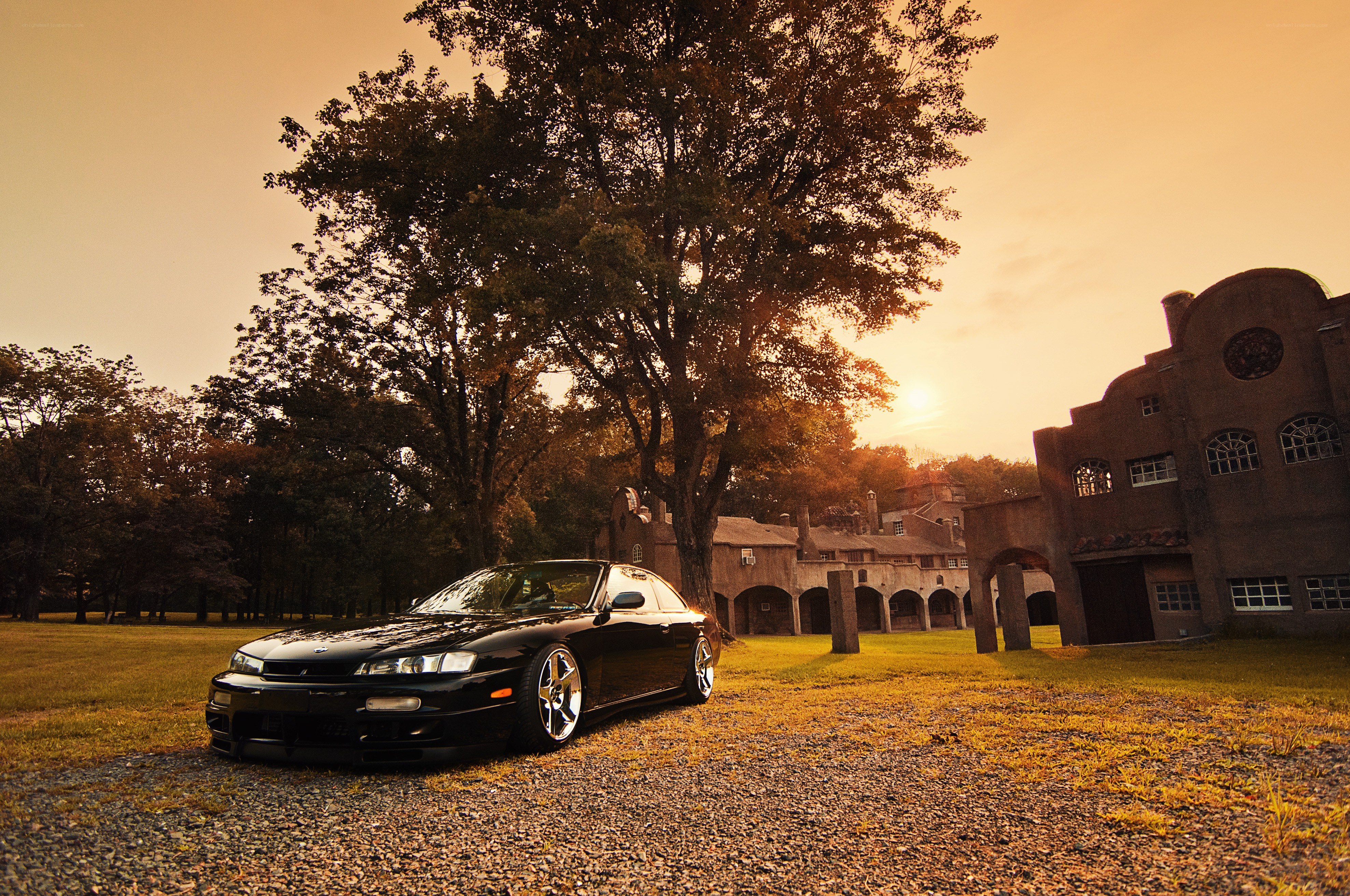Black car at sunset by a building