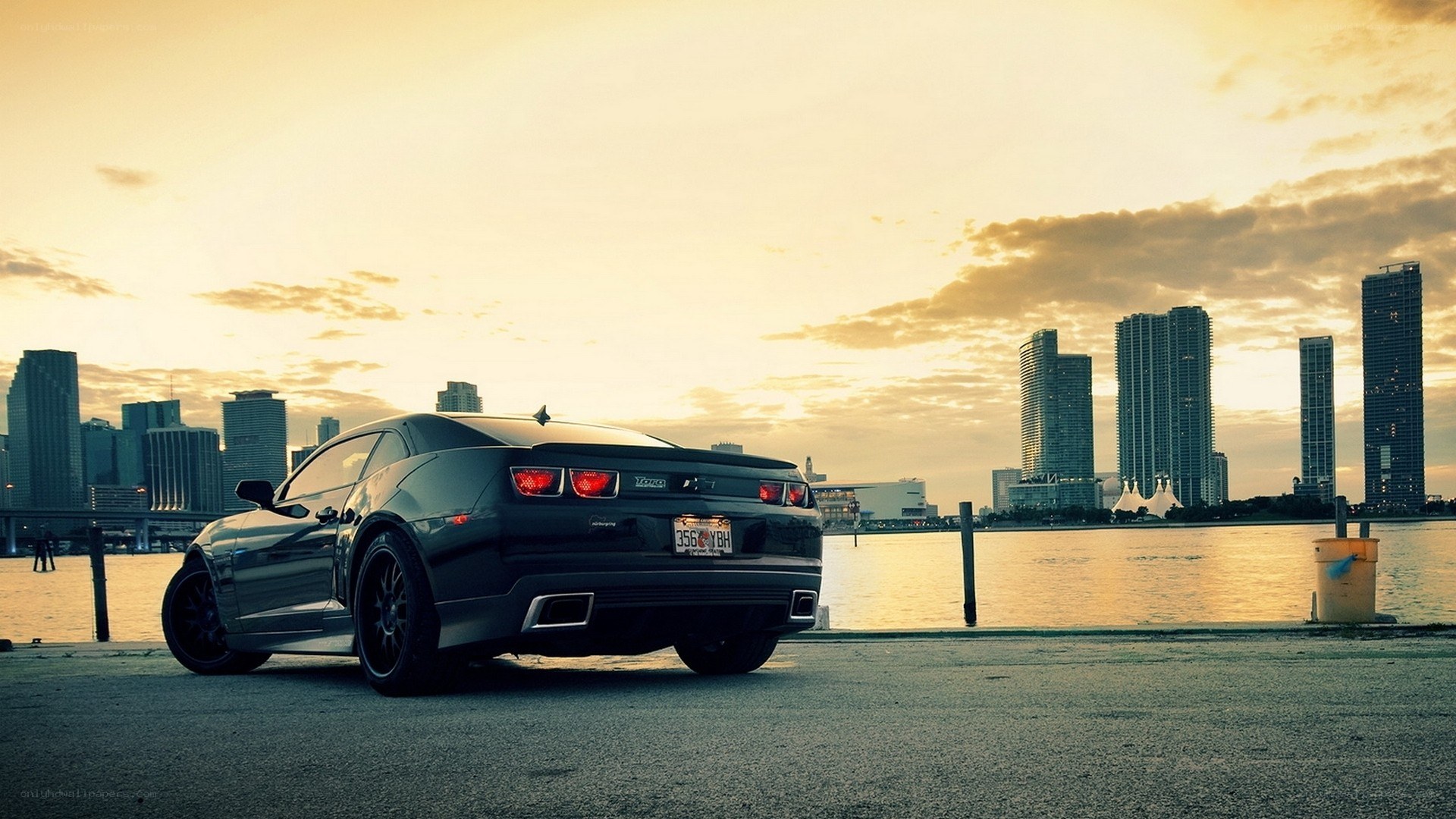 Black car at sunset by city