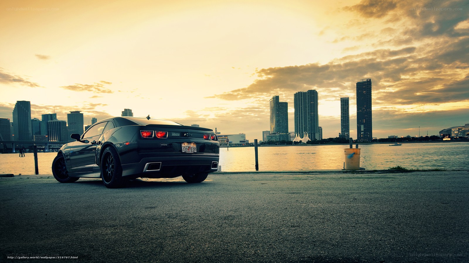 Black car at sunset by city