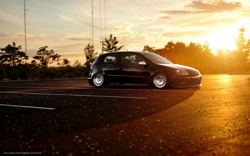 Black car at sunset in parking lot