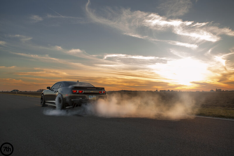 Black Car Burning Tire