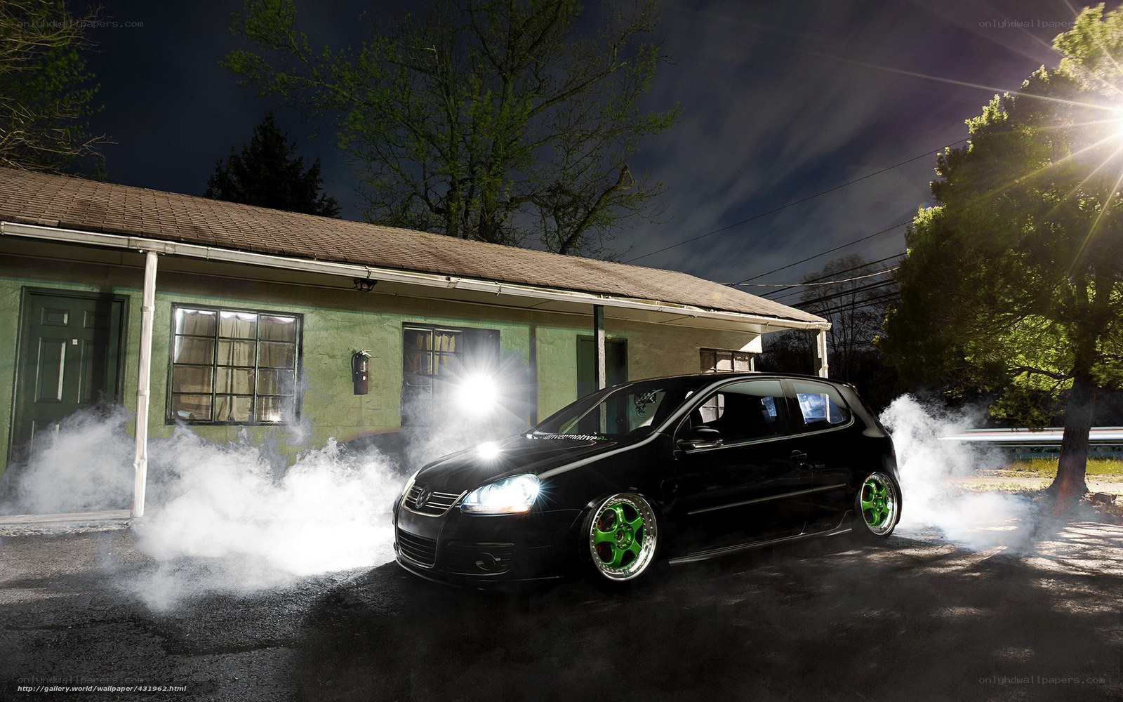 Black car doing burnout at night
