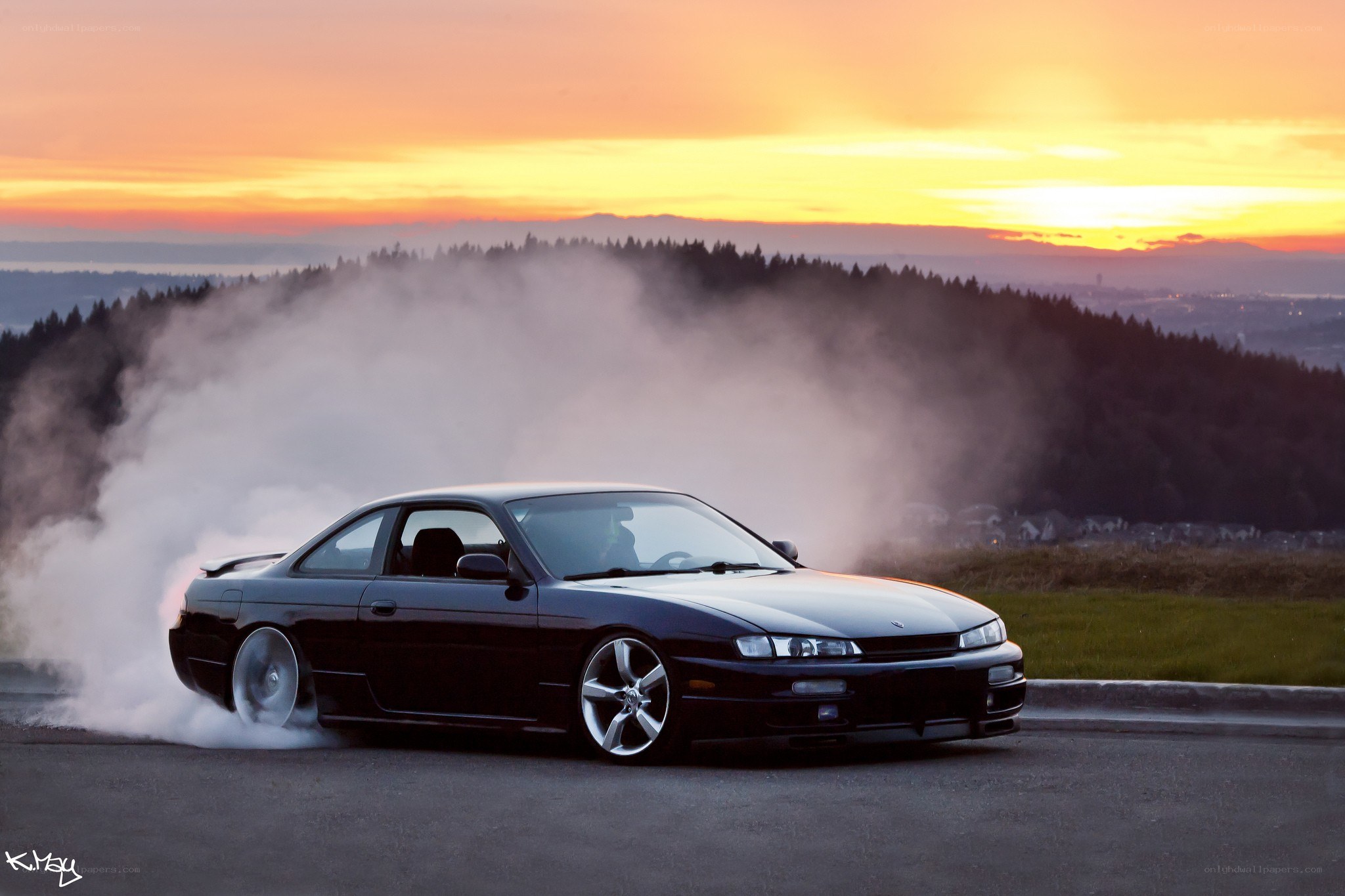 Black car drifting at sunset