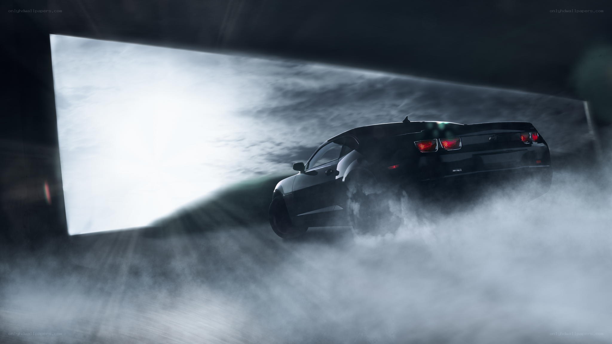 Black car drifting in smoke