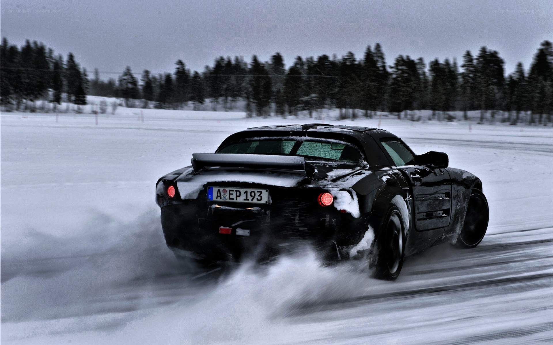Black car drifting in snow