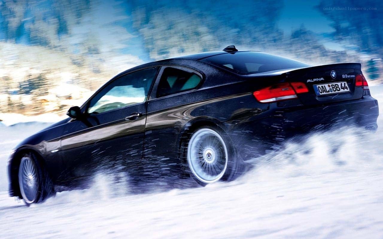 black car drifting in snow