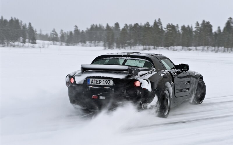 Black car drifting in snow