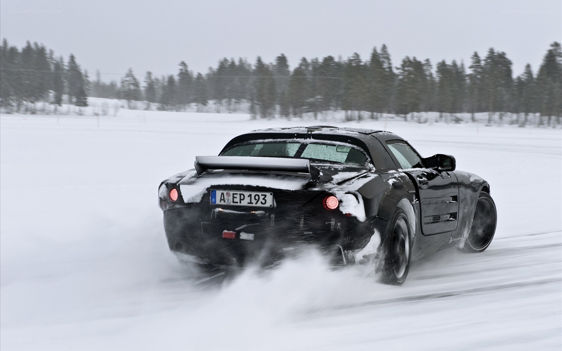 Black car drifting in snow