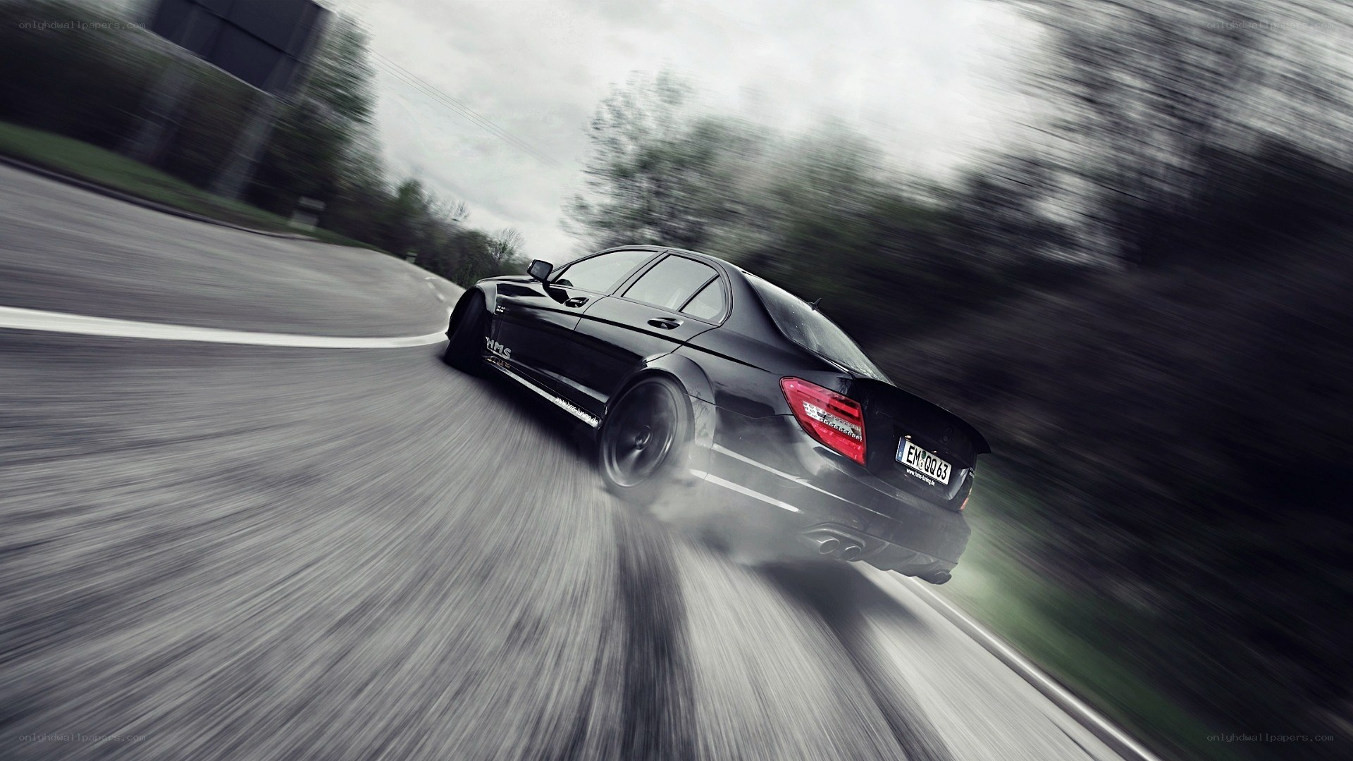 black car drifting on road