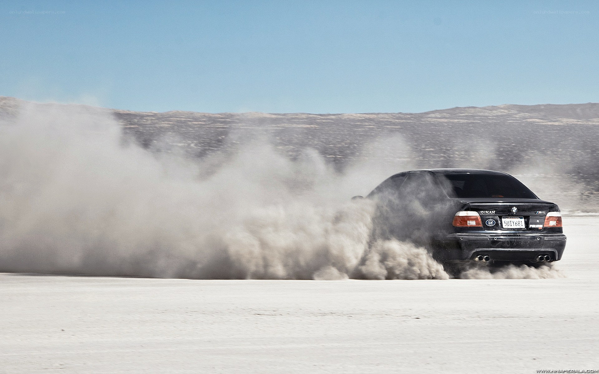 Black car drifting on salt flat
