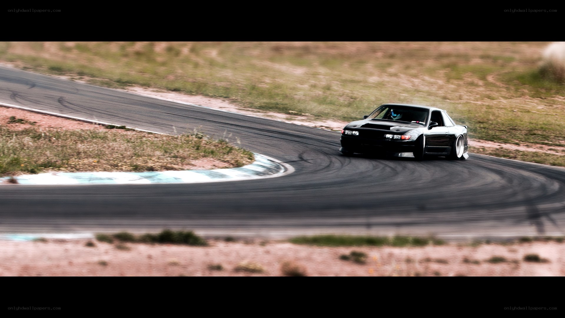 black car drifting on track
