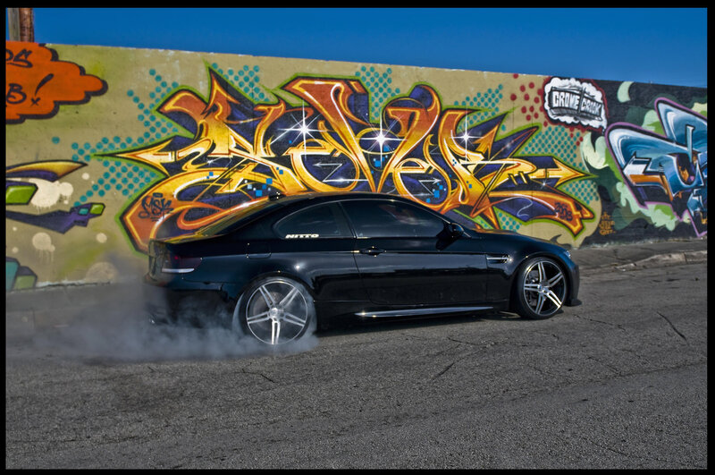 Black car drifting with smoke