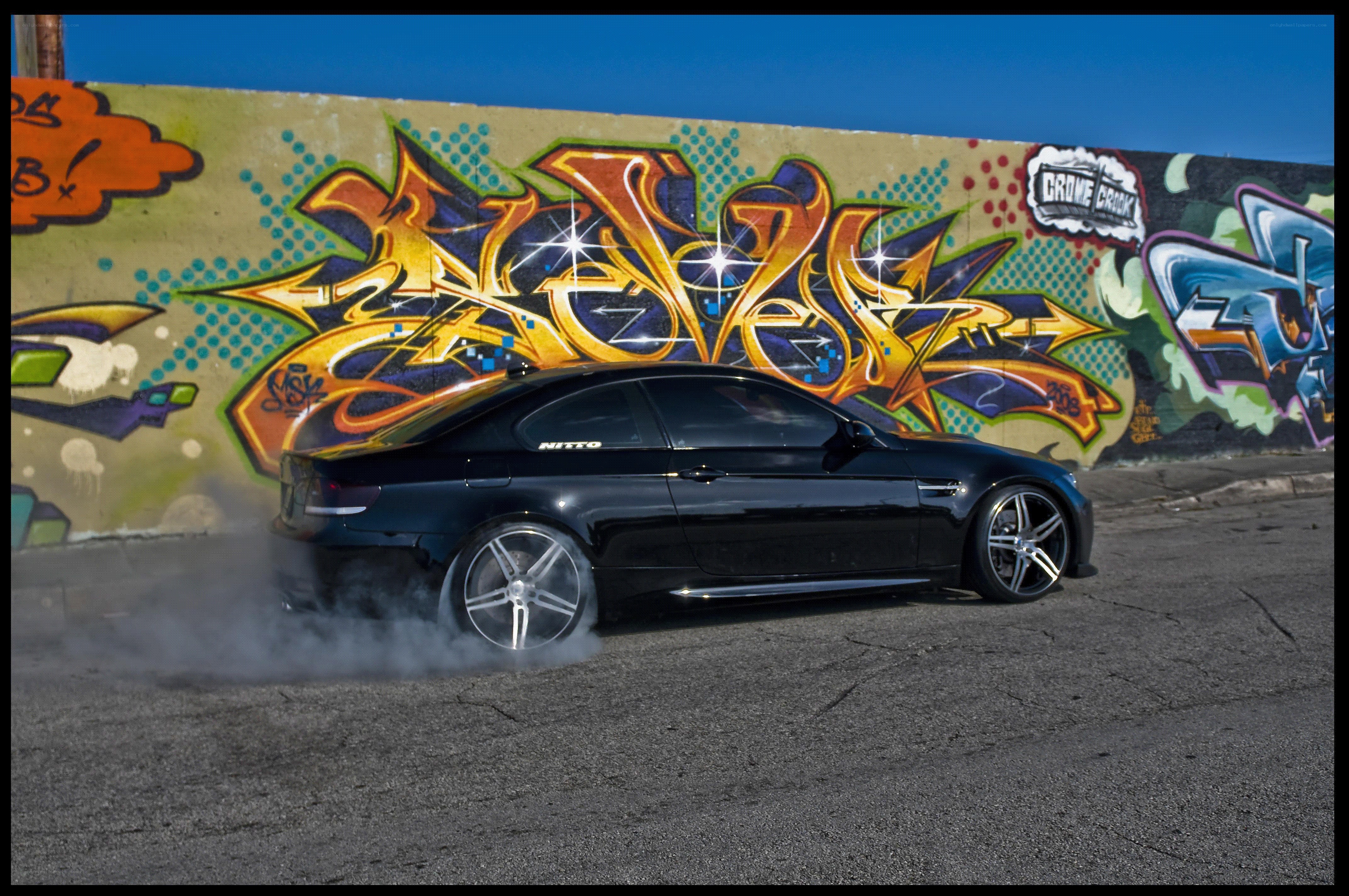 Black car drifting with smoke