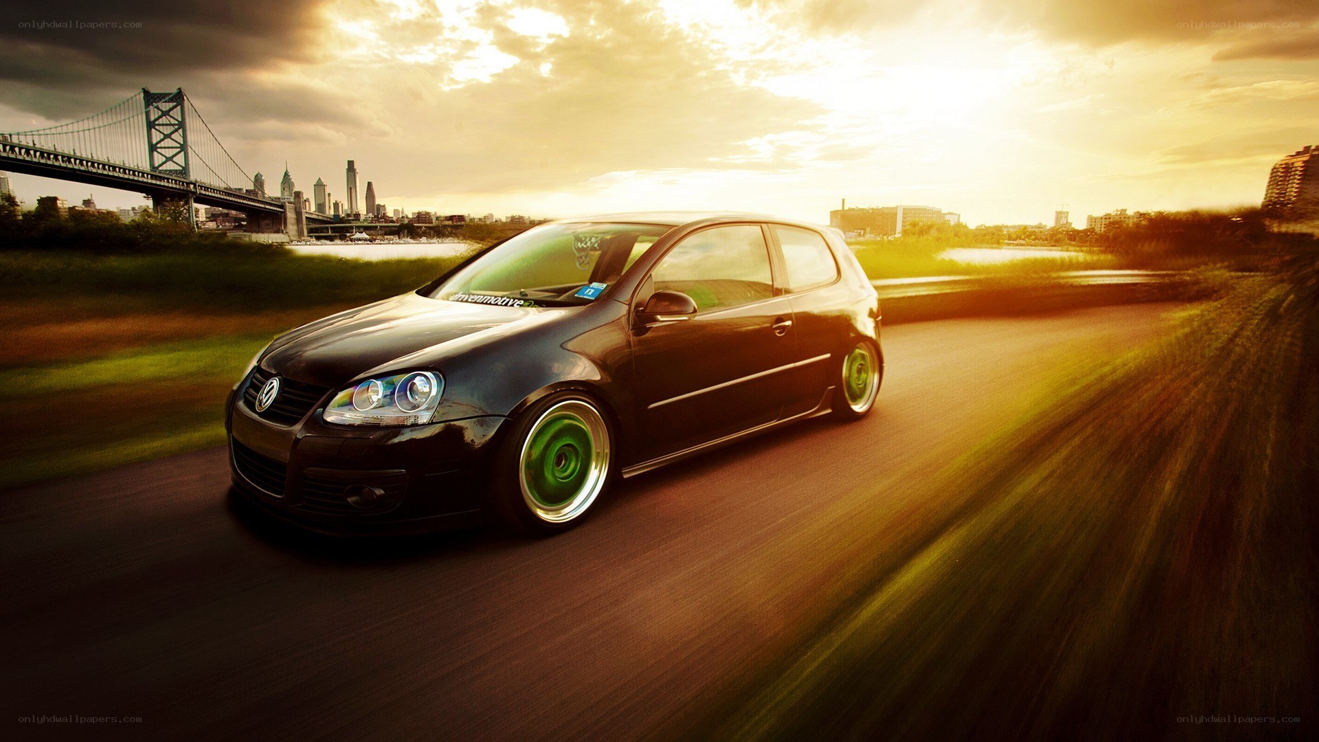 black car driving at sunset