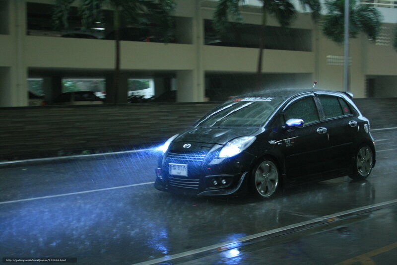 Black car driving in rain