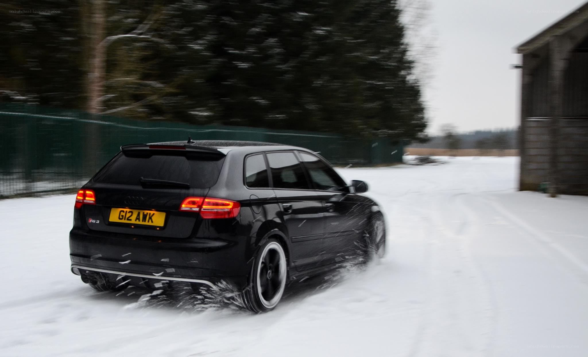 black car driving in snow